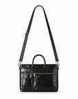 Classic black full-grain leather briefcase with raised detachable shoulder strap and gold-tone swivel clasps.