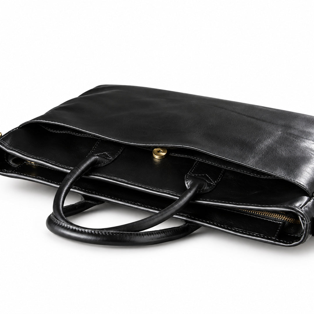 Classic black full-grain leather briefcase rear slip pocket with a gold-tone snap closure