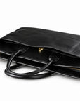 Classic black full-grain leather briefcase rear slip pocket with a gold-tone snap closure