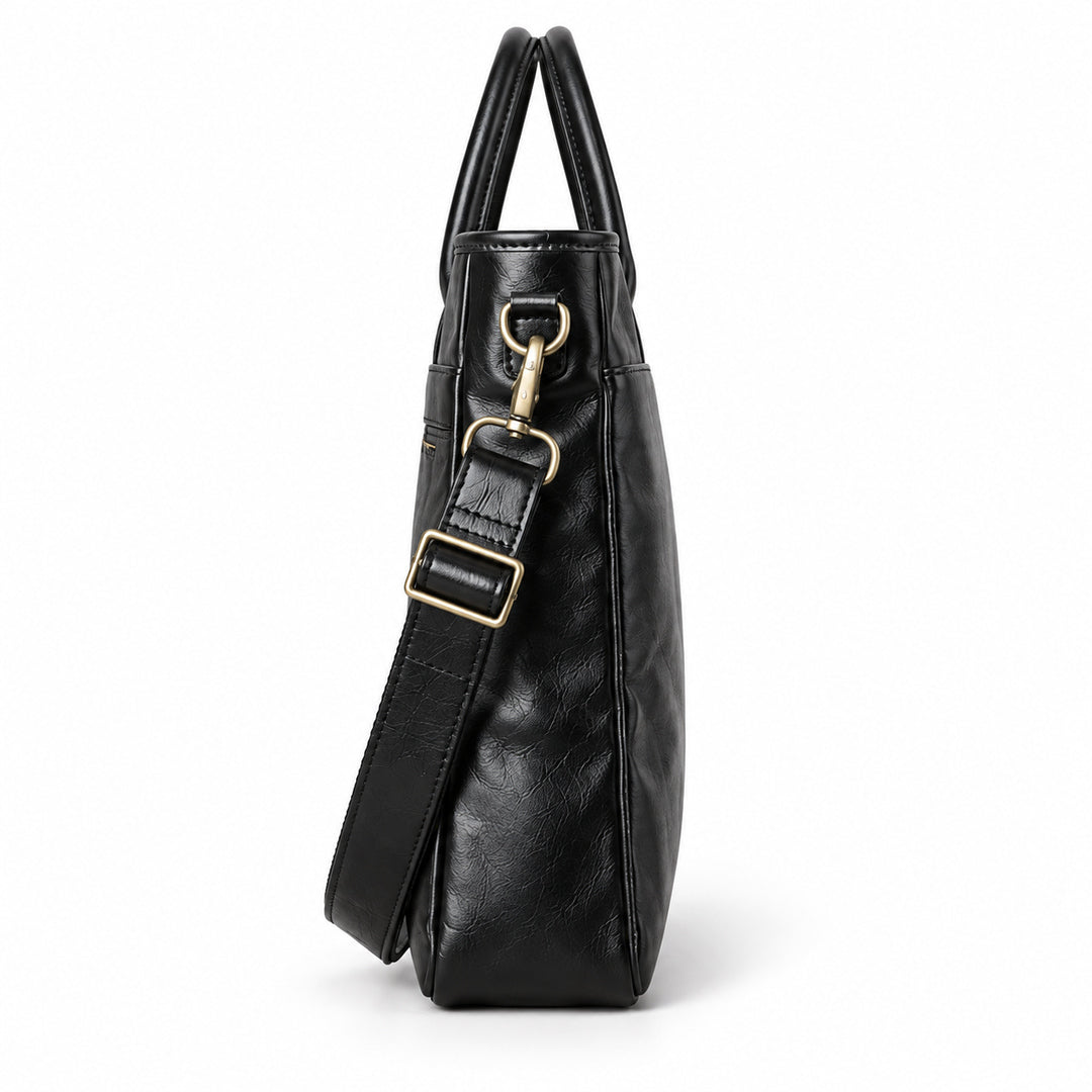 Classic black full-grain leather briefcase side profile with a narrow gusset and detachable strap