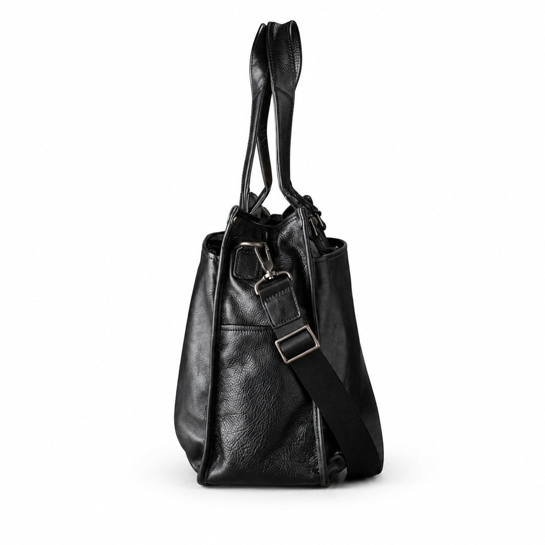 Classic black full-grain leather tote side view with a detachable strap and metal adjuster