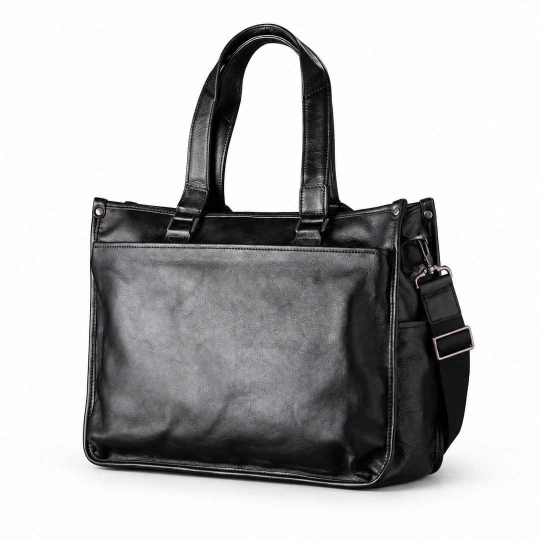 Classic black full-grain leather tote with long handles and a detachable shoulder strap, three-quarter view