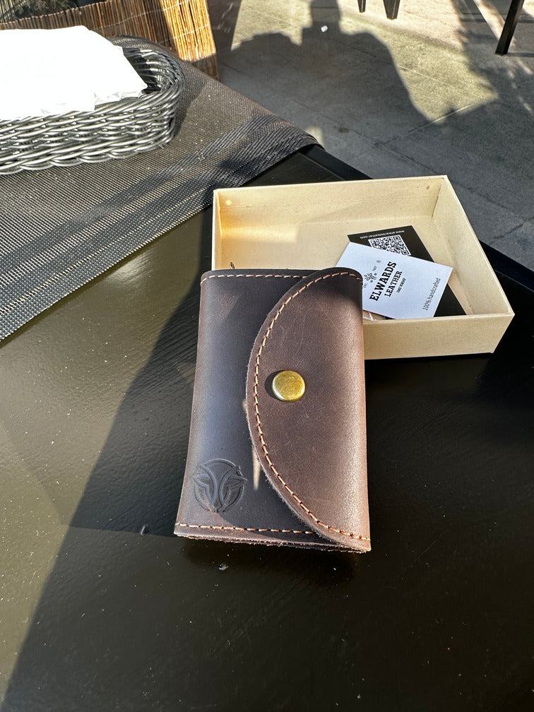 Classic handmade key case with strong stitching and a smooth brown leather finish.