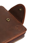 Close-up of a brown leather wallet's Elwards Leather logo and secure button clasp, showcasing premium craftsmanship.