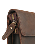 Close-up of the zip and detailing on a dark brown Crazy Horse leather clutch, highlighting quality and craftsmanship.