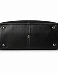 Elegant black full-grain leather duffel bag base with five protective metal feet.
