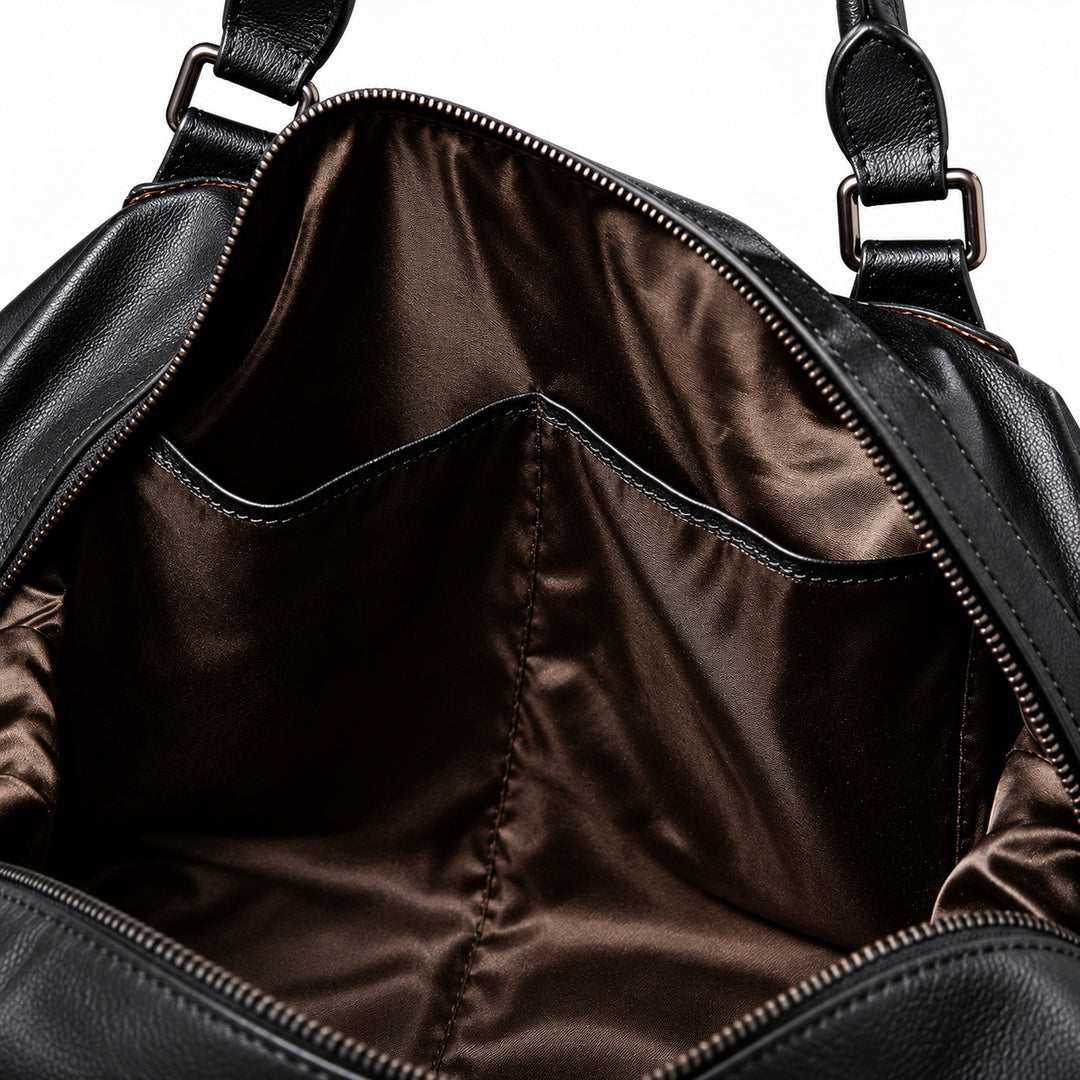 Elegant black full-grain leather duffel bag interior with two open organizer pockets.