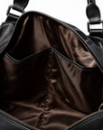 Elegant black full-grain leather duffel bag interior with two open organizer pockets.
