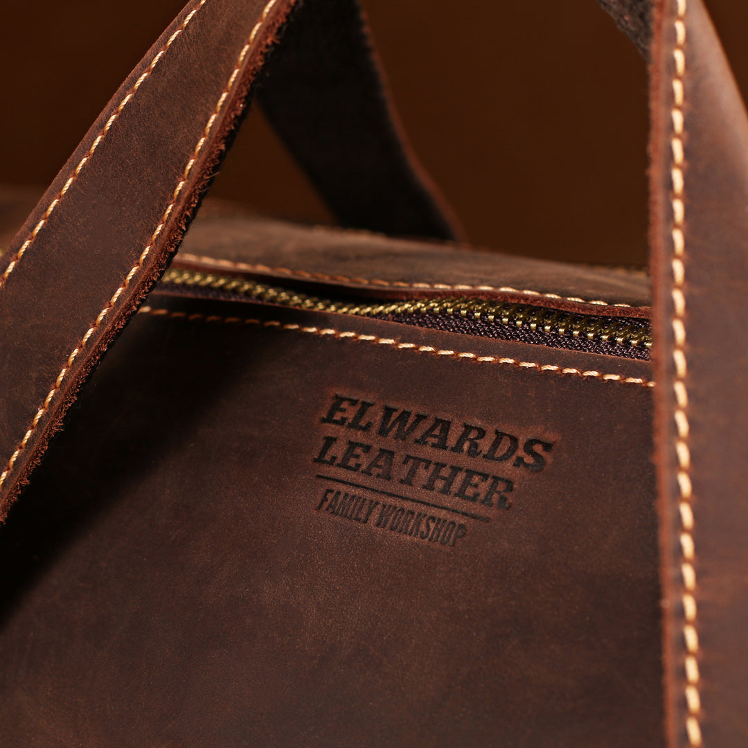 Elwards Leather branding on interior of full-grain crazy horse leather duffle bag, designed for style and durability.