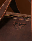 Elwards Leather branding on interior of full-grain crazy horse leather duffle bag, designed for style and durability.