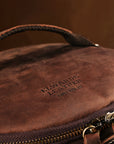 Focus on the Elwards Leather logo embossed on a leather backpack, emphasizing craftsmanship and brand identity.