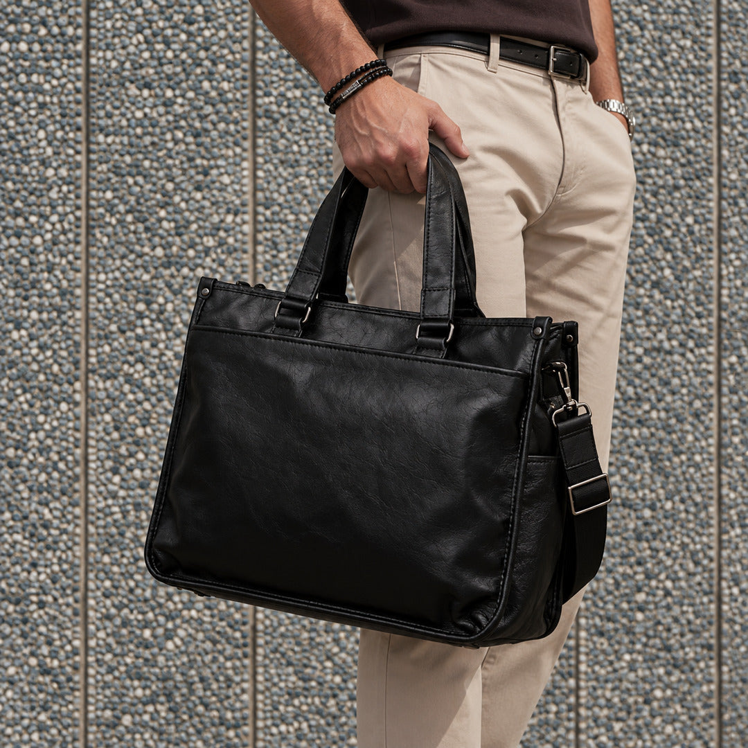 Executive black leather laptop briefcase for men with dual carry handles, detachable shoulder strap and structured rectangular design