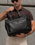 Executive black leather business bag for men with top handles, shoulder strap and spacious briefcase design