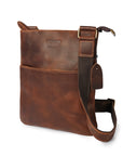 Close-up front view of brown leather crossbody bag, focusing on the smooth texture and precise hand-stitching