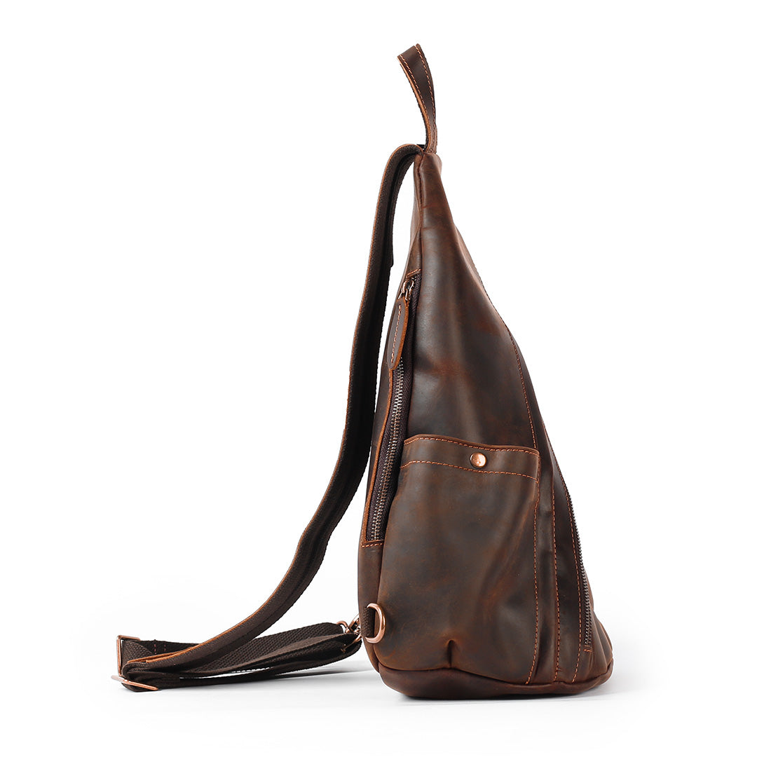 Brown leather sling bag on a white background