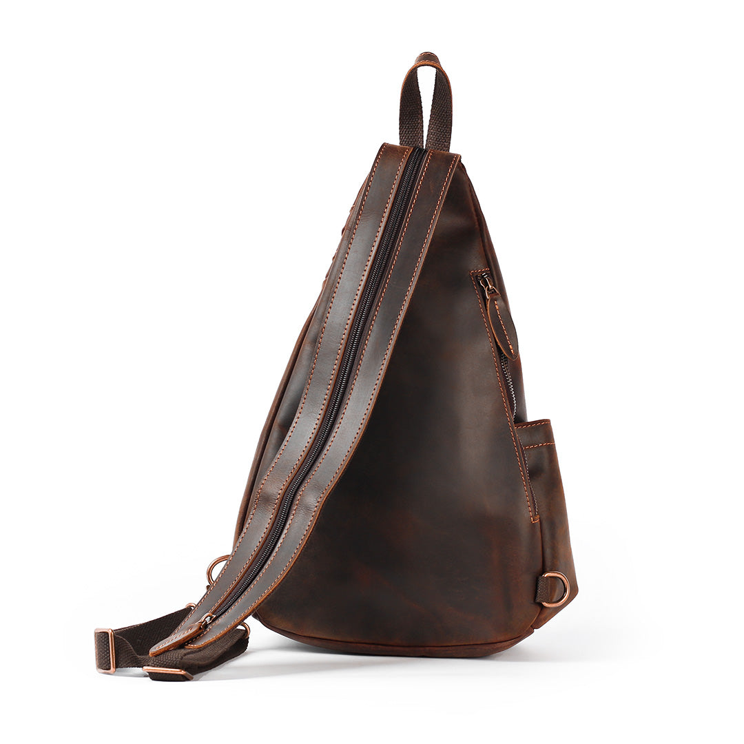 Brown leather sling bag on a white background