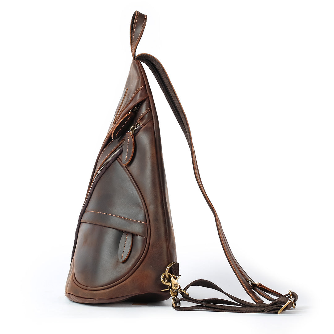 Brown leather sling bag on a white background