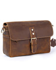 Brown leather bag with a strap on a white background