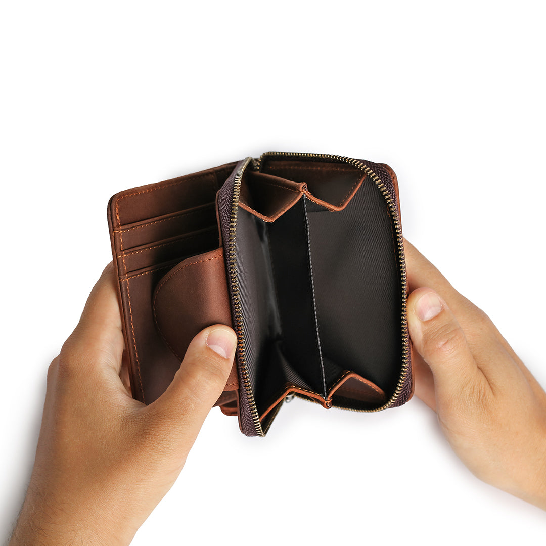 Hands holding a premium leather wallet, showcasing spacious compartments for organized storage.