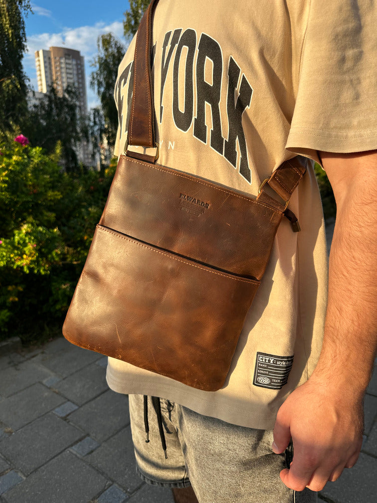High-quality brown crossbody leather bag for men with a sturdy handle and adjustable strap.