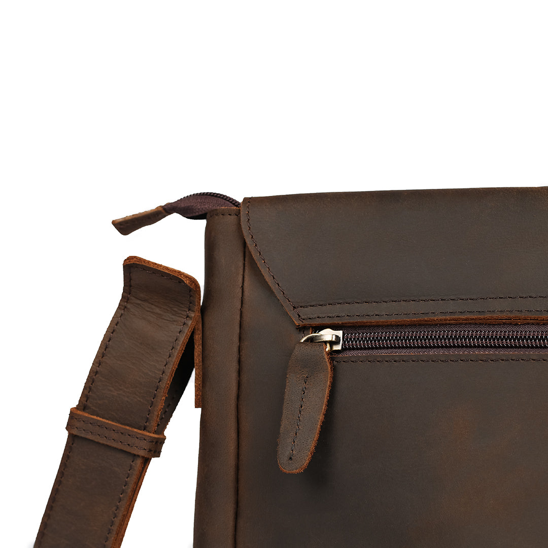 High-quality zipper detail on a dark brown leather messenger bag for secure storage and elegant style