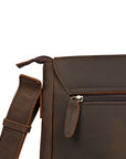 High-quality zipper detail on a dark brown leather messenger bag for secure storage and elegant style