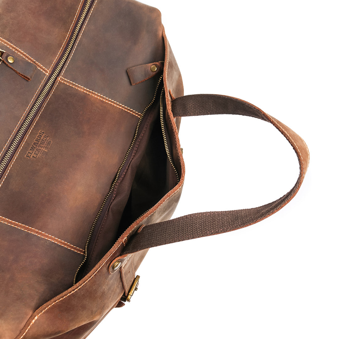 Interior of vintage crazy horse leather bag with open compartments, ideal for travel essentials and everyday use.