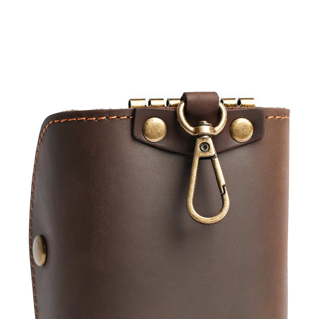 Handmade leather key case packaged in a soft branded pouch, emphasizing its premium craftsmanship and vintage style.