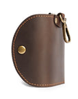 Handmade leather key case with snap button closure and brass hardware, designed for functionality and vintage appeal.