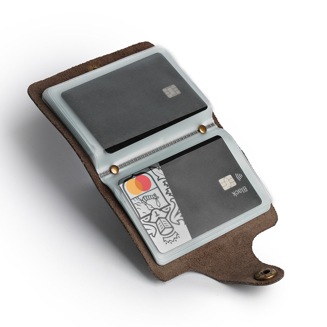 Leather card holder displaying stored credit cards in transparent sleeves, perfect for travel and business.