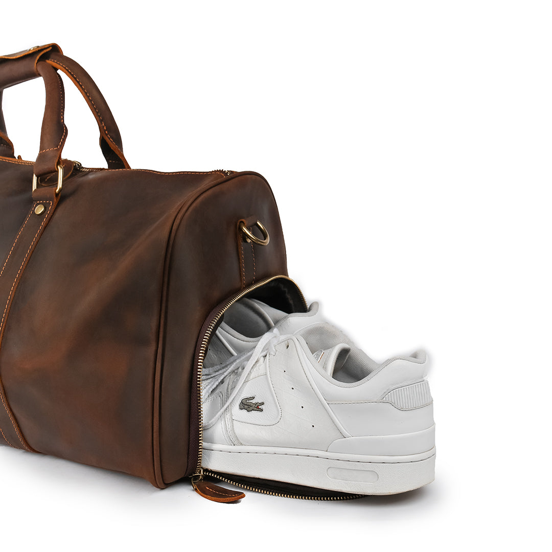 Close-up of the dedicated shoe compartment in a premium Crazy Horse leather duffle bag, perfect for organized travel.