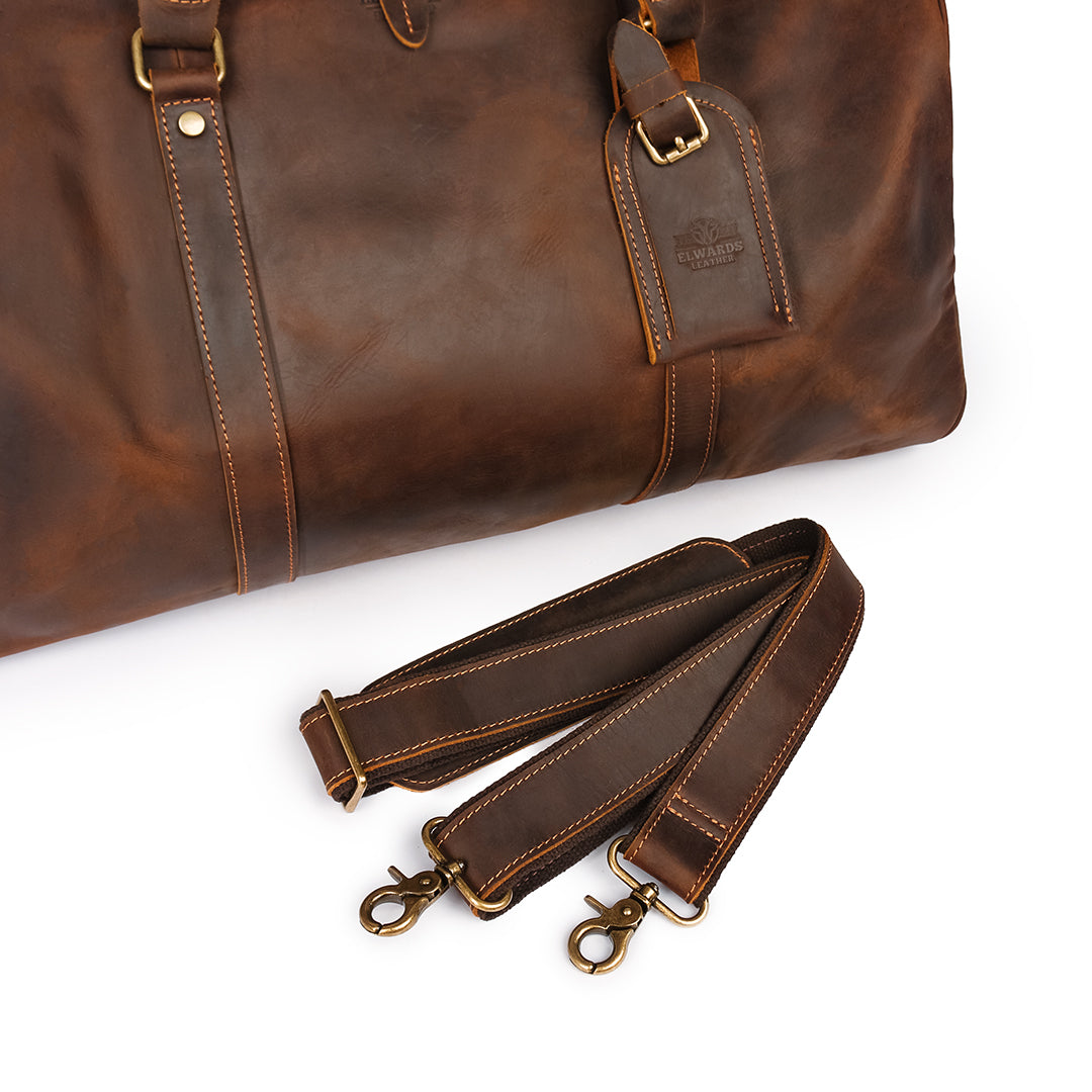 Premium leather shoulder strap for a duffle bag with shoe compartment, detachable and adjustable for easy carrying.