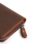 Brown leather wallet displayed with soft suede lining and transparent card slots for organized storage.