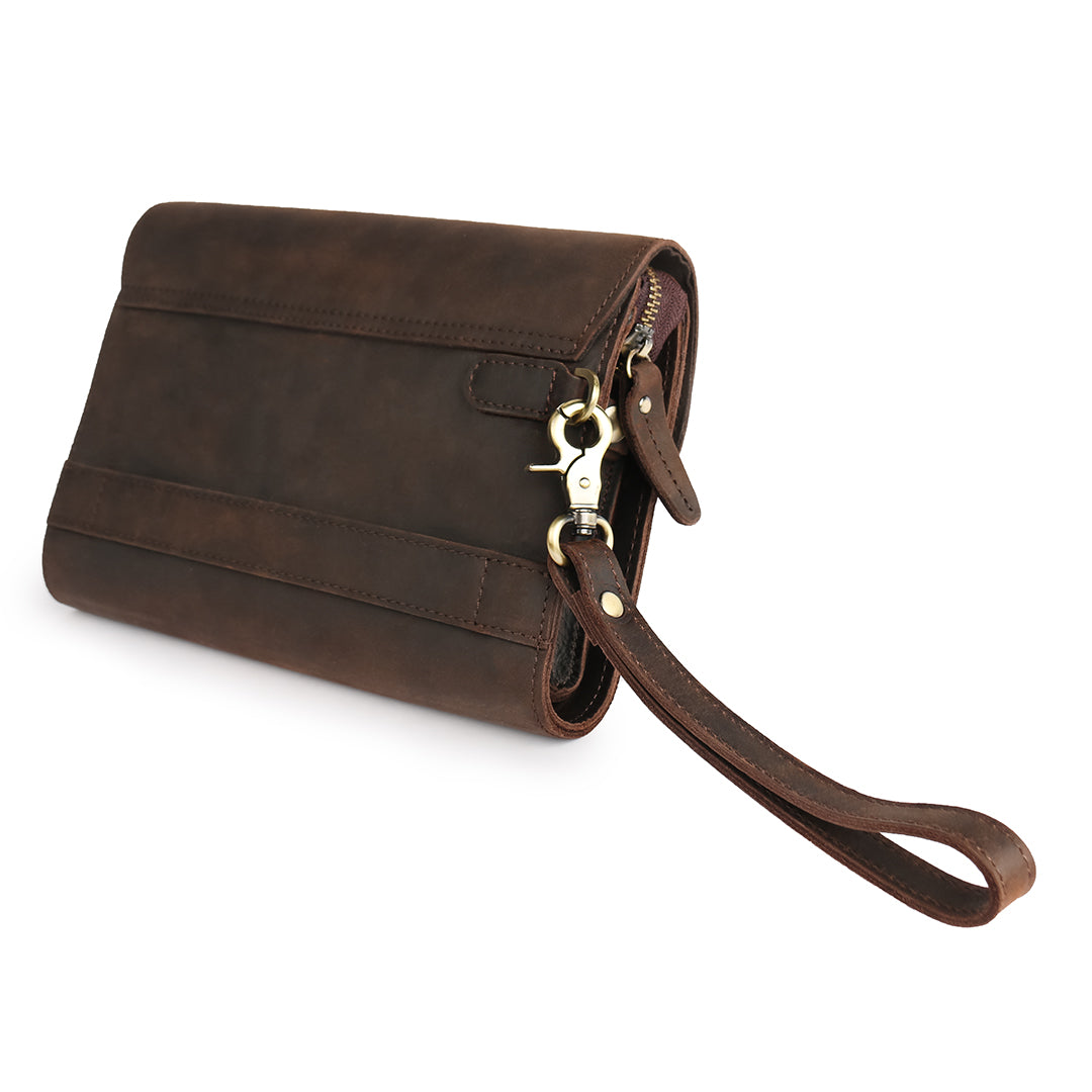 Back view of a dark brown leather wrist bag with an adjustable wrist strap, showcasing sturdy construction and design.