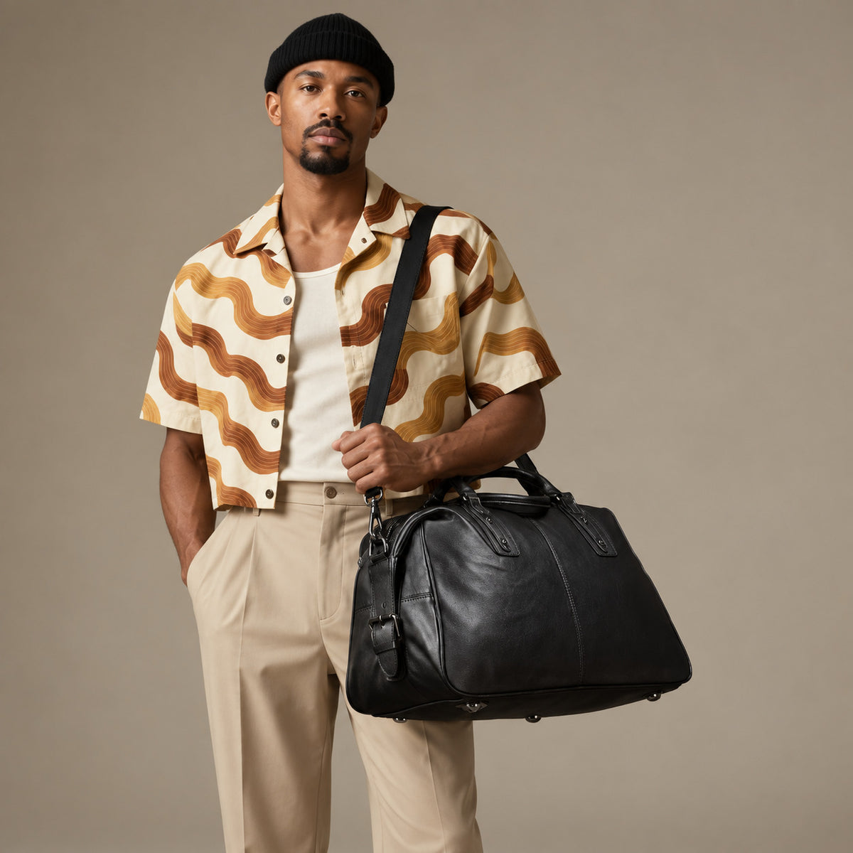 Luxury black leather duffle bag for men with top handles, adjustable shoulder strap and spacious weekender design