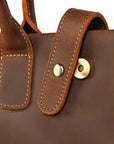 Magnetic clasp detail on a premium men's Crazy Horse leather bag.