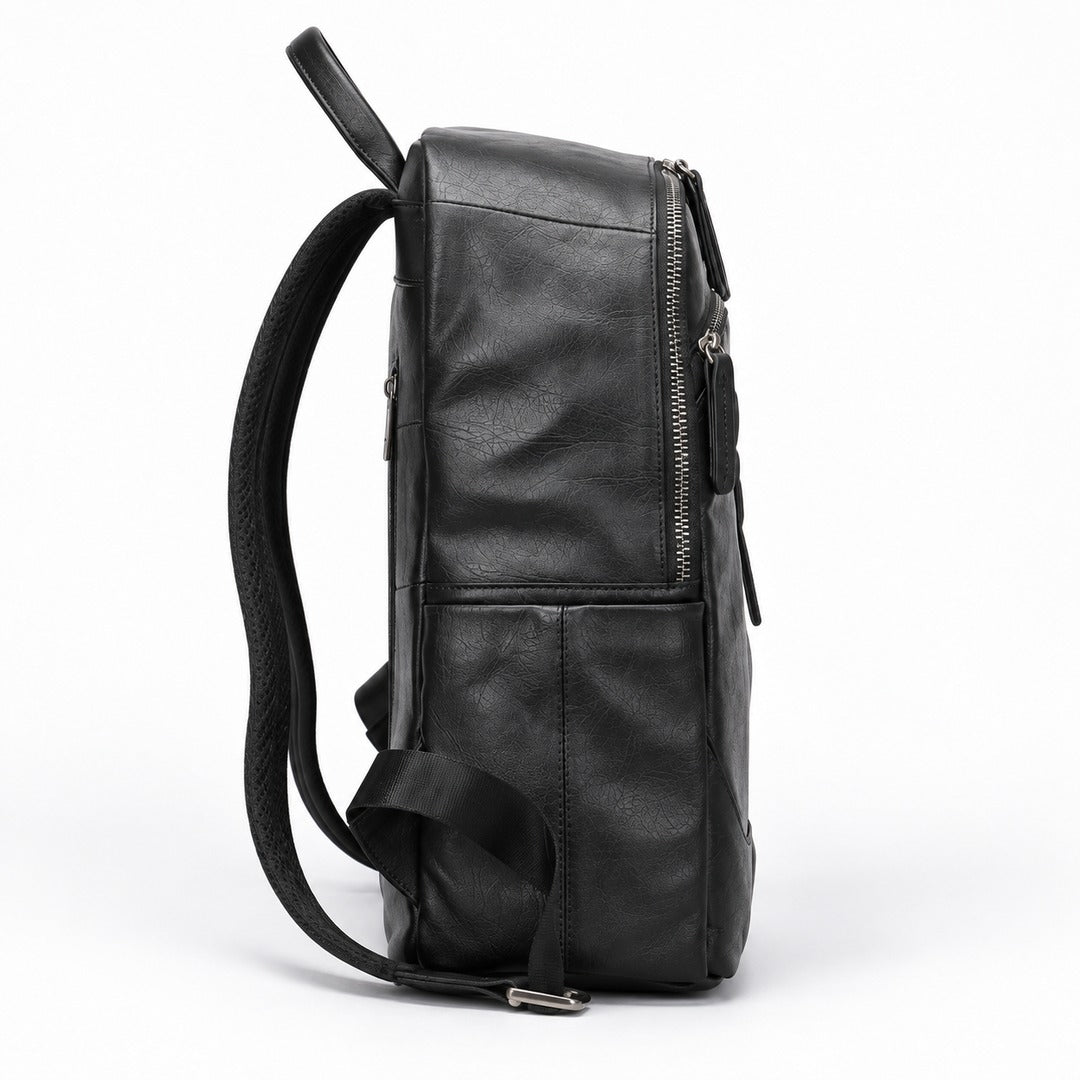 A black leather backpack shown from a side profile view, featuring a front zippered pocket and a padded shoulder strap, set against a plain white background.