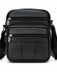 Black pebbled leather crossbody bag with multiple zippered compartments and a wide adjustable shoulder strap, shown on a clean white background.