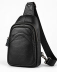 Black textured leather sling bag with a single shoulder strap, shown on a clean white background.