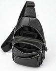 Black pebbled leather crossbody bag with multiple zippered compartments and an adjustable shoulder strap, shown open on a white background.