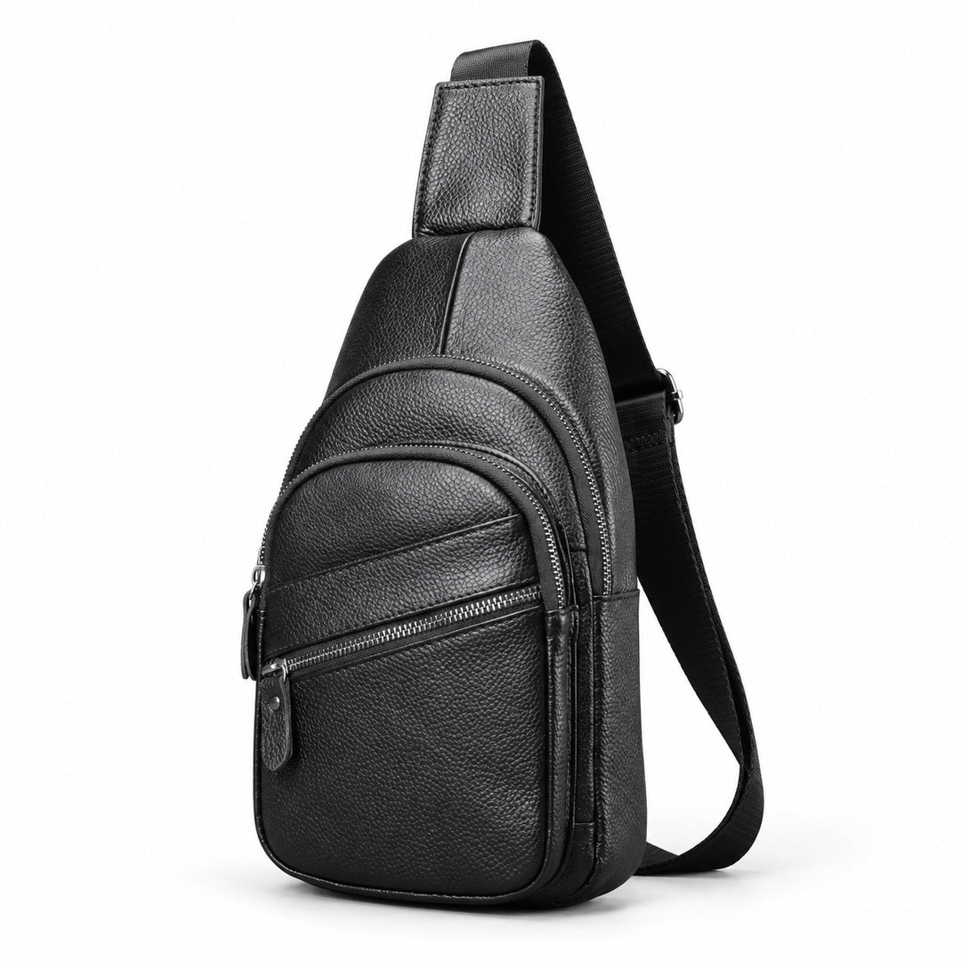 Black pebbled leather sling bag with a front zippered pocket and adjustable shoulder strap, shown on a white background.