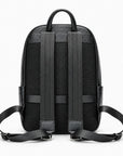 Black backpack shown from the back, featuring a textured mesh back panel, wide padded shoulder straps, and adjustable side straps on a clean white background.