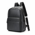 A black leather backpack with a front zippered pocket and adjustable shoulder straps, shown from a three-quarter angle on a white background.