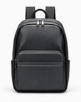 A black pebbled leather backpack with a top handle, dual zipper compartments, and side pockets, shown against a plain white background.
