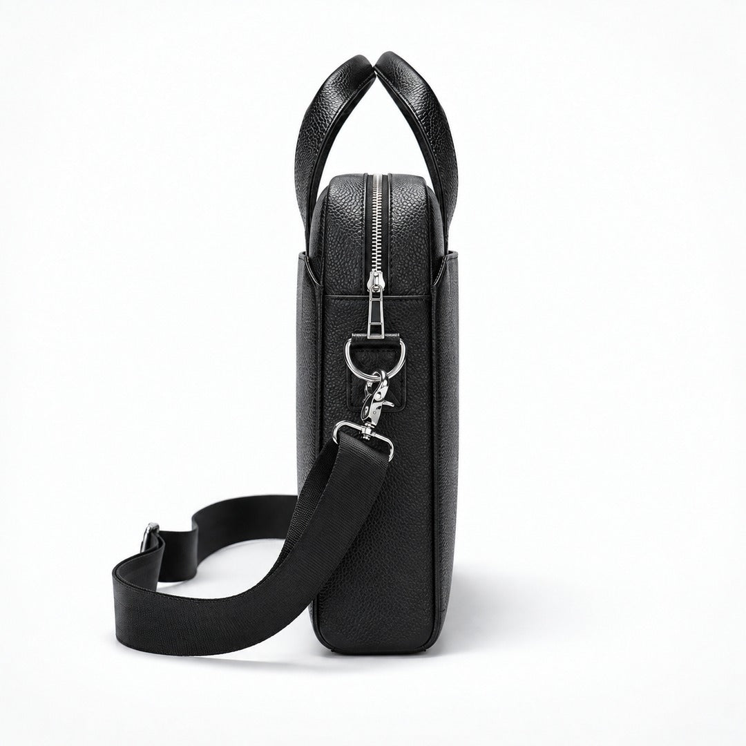 A black pebbled leather briefcase or shoulder bag shown from the side profile on a clean white background. It features a top zipper, silver-tone hardware, and a detachable black shoulder strap.