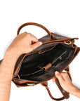 Men's brown Crazy Horse leather shoulder bag with a laptop and accessories, perfect for a professional look