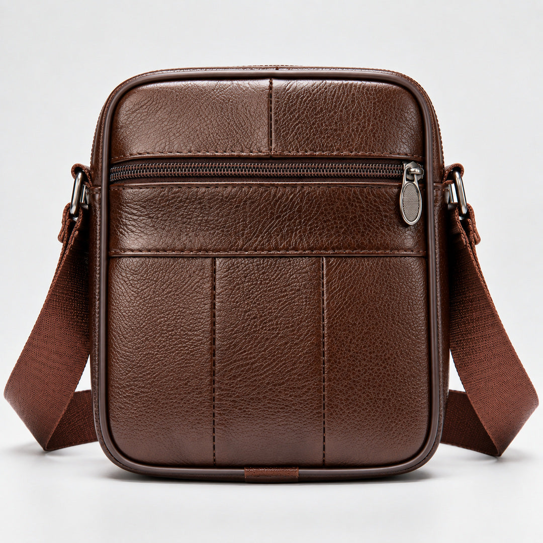 A brown textured leather crossbody bag with a matching adjustable shoulder strap, shown against a plain light gray background.