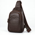 A dark brown textured leather sling bag with an adjustable shoulder strap, shown from a three-quarter angle on a white background.