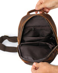 Men’s brown leather sling bag interior with multiple compartments
