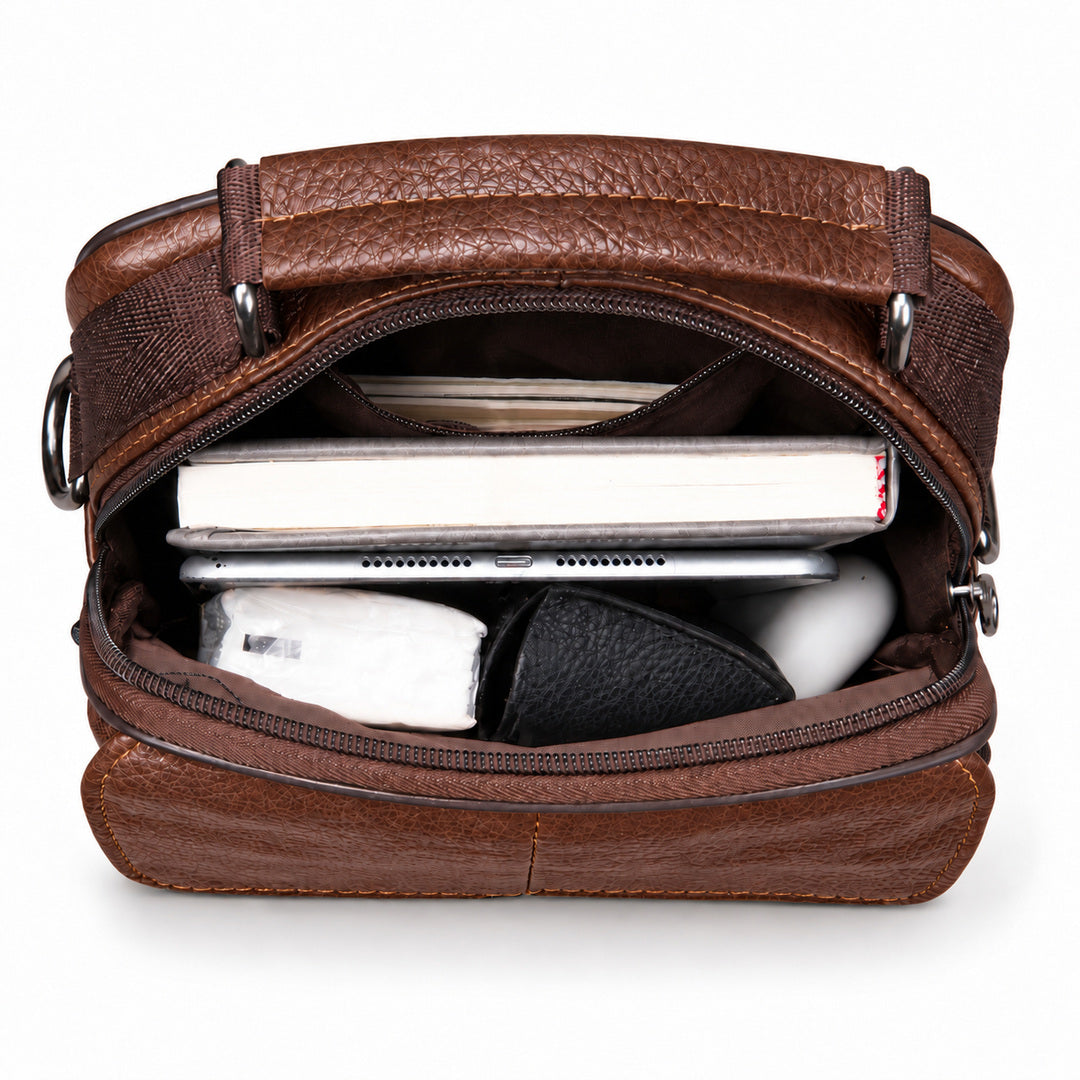 A brown textured leather zippered pouch or organizer shown open, revealing storage compartments filled with a tablet, notebook, and other small accessories, on a plain white background.